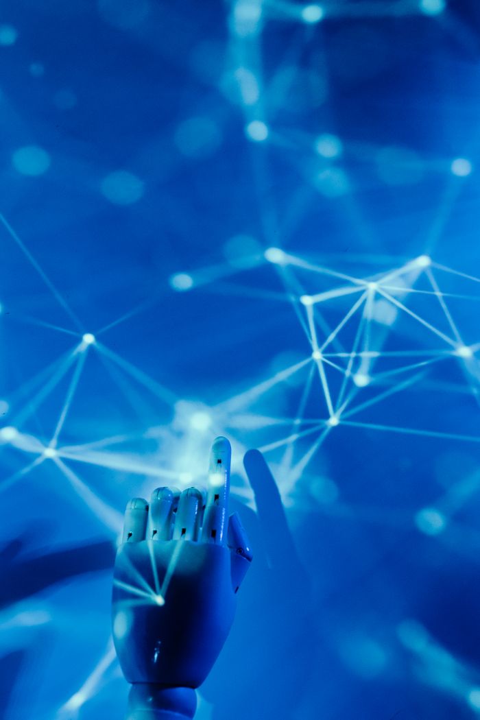 Crafting Captivating Headlines: Your awesome post title goes here Futuristic robotic hand touching a digital network on a blue background.